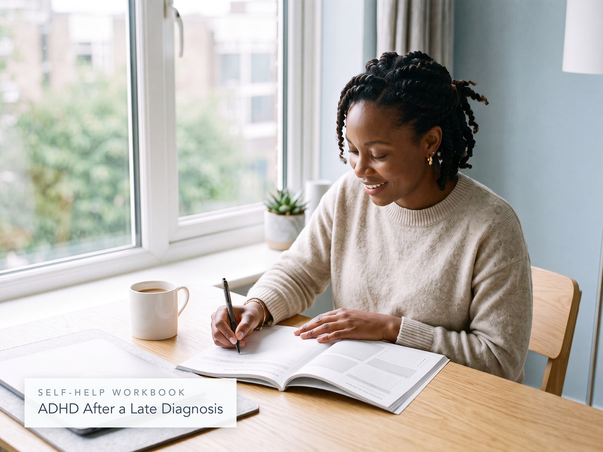 Woman writing in the ADHD After a Late Diagnosis workbook at her desk
